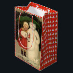 Meisje in de rode jas met Snowman, witte kerst Medium Cadeauzakje<br><div class="desc">Kerstcadeautas -  afbeelding van een klein meisje in een rode jas die een lachende sneeuwman beschermt met een groene paraplu.</div>