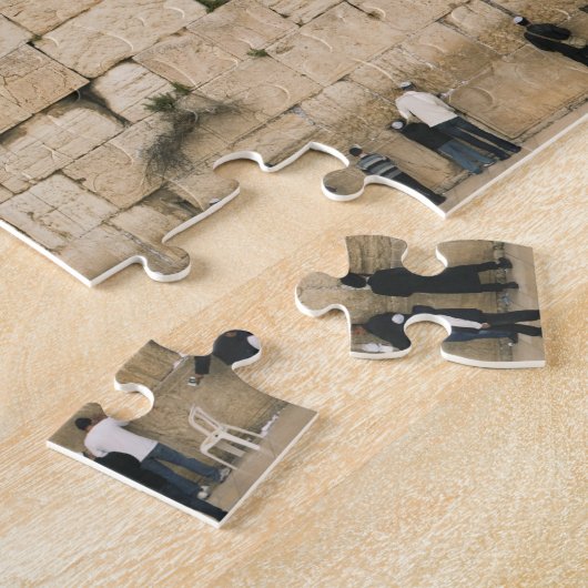 Mensen bidden aan de wand legpuzzel (Zijkant)