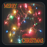 "Merry Christmas" krans w / Lights Square Sticker<br><div class="desc">Vierkante sticker toont een krans versierd met veelkleurige bollen en een tekstoverlay die zegt: "Vrolijk kerstfeest." Afgeschuinde hoeken verbeteren de houdbaarheid van de sticker (adhesie) door de neiging tot vastlopen te verminderen. Verkrijgbaar in vellen van 6 (zes) 3-inch stickers of 20 (twintig) 1-en-1/2-inch stickers.</div>