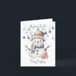 Merry kerst Snowman Feestdagen Kaart<br><div class="desc">Wens iemand een speciale kerst met deze schattige kaart. Een schattige waterverf sneeuwman met een pet en sjaal en een grote vrolijke glimlach. Achter hem hangen een paar blauwe balletjes aan een touwtje. Boven en onder staat de tekst Wishing you a Merry Christmas in a black script.</div>