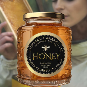 Metaalgoudhoning op zwart met bijen en rand ronde sticker