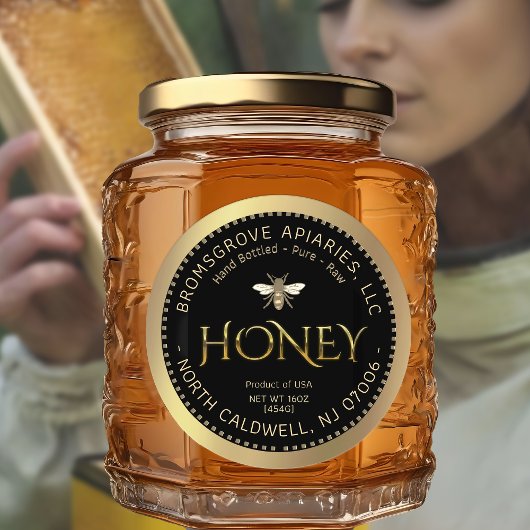 Metaalgoudhoning op zwart met bijen en rand ronde sticker