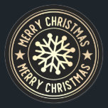 Metallic goud Merry Christmas Sneeuwvlok op zwart Ronde Sticker<br><div class="desc">Een iriserend metalen gouden embleem met de woorden "Merry Christmas" herhaald langs de boven- en onderkant van het label op een zwarte achtergrond. Gouden sneeuwvlok in het midden.</div>