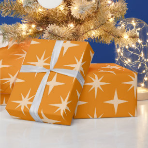 Midden eeuw atomaire stervuurwerkpatroon op oranje cadeaupapier