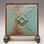 Mideeuwse geometrische elegantie aards Blauwgroen Tegeltje<br><div class="desc">Verhoog uw ruimte met de chique verfijning van de "Geometric Elegance Ceramic Print Tegel". Deze tegel is voorzien van een boeiend geometrisch patroon met lagen concentrische vierkanten en een middendiamant, weergegeven in rustgevende tonen van blauwgroen, geaccentueerd met aardse bruinen en geplaatst tegen een warme, crème achtergrond. Het ontwerp bootst de...</div>