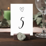 Minimalist Wedding Table Number Card with Heart Kaart<br><div class="desc">Description Complete your reception table décor with this elegant minimalist wedding table number card featuring a clean black-and-white design with a delicate heart illustration above a stylish script table number. The simple yet romantic layout creates a timeless look that blends beautifully with modern, classic, or minimalist wedding themes. The bold...</div>