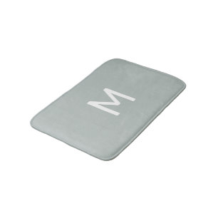 Minimalistisch wit monogram op grijs badmat