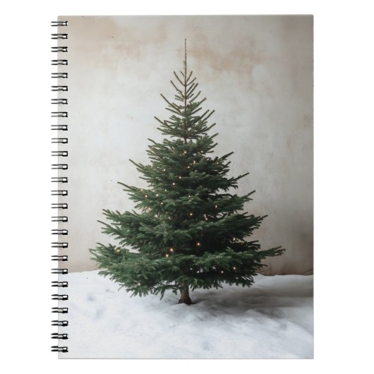 Minimalistische kerstboom met zachte lichten op sn notitieboek (Voorkant)