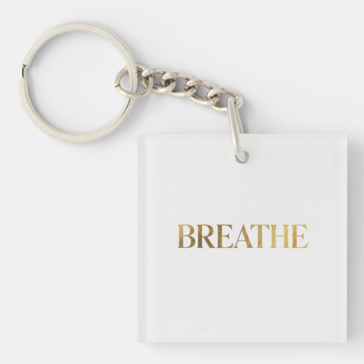 Minimalistische typografie met het gouden woord ad sleutelhanger (voorkant)