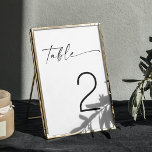 Minimalistische zwart-wit moderne script bruiloft kaart<br><div class="desc">Verhoog uw bruiloft decor met deze minimalistische zwart-wit tafel nummer, met elegante script typografie. Het ontwerp biedt een schone en moderne esthetiek, waardoor het een veelzijdige keuze is voor verschillende huwelijksthema's, waaronder hedendaagse, rustieke of klassieke stijlen. Ideaal voor koppels die op zoek zijn naar een verfijnde en tijdloze look, dit...</div>