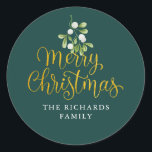 Mistletoe Script Gold Merry Christmas Familienaam Ronde Sticker<br><div class="desc">Mistletoe script gold Merry Christmas familienaam classic ronde sticker. Fijne waterverf mistletoe groen hangt boven chic gouden script Merry Christmas typografie op deze elegante stickers. Personaliseer met je familienaam. U kunt de achtergrondkleur aanpassen aan uw vakantiethema. Ontworpen door Thisnotme©</div>