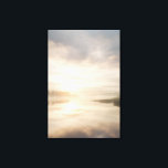 Misty Lake Sunrise Golden Reflection Canvas Afdruk<br><div class="desc">Soft golden sunlight pierces through thick morning mist over a calm lake, creating a luminous path of reflection across the water. Tall reeds line the shore while distant trees fade into the haze, and the sky blends warm peach and rose tones into pale blue-gray. The composition radiates profound stillness, gentle...</div>