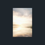 Misty Lake Sunrise Golden Reflection Canvas Afdruk<br><div class="desc">Soft golden sunlight pierces through thick morning mist over a calm lake, creating a luminous path of reflection across the water. Tall reeds line the shore while distant trees fade into the haze, and the sky blends warm peach and rose tones into pale blue-gray. The composition radiates profound stillness, gentle...</div>