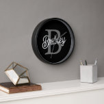 Modern Elegant Monogram Naam Zwart Grijs Script<br><div class="desc">De Modern Elegant Monogram Name Black Grey Script Clock is een verfijnde toevoeging aan elke ruimte, waarbij functionaliteit wordt gecombineerd met stijl. Met een strak zwart gezicht met grijs schrift, is deze klok gepersonaliseerd met een elegant monogram en naam, waardoor het een uniek en verfijnd uurwerk is. Ideaal voor thuis-...</div>