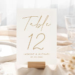 Modern Goud Script Bruiloft Tafel Nummer Kaart<br><div class="desc">Eenvoudige, moderne bruidstafel nummerkaarten met "Tafel" weergegeven in een handgeschreven gouden script met een witte achtergrond (of een kleur naar keuze). Om de gouden kaarten van de huwelijkstafel te bestellen: voeg jouw namen, trouwdatum en tabelnummer toe. Elk nummer moet afzonderlijk aan uw winkelwagen worden toegevoegd. Nadat u klaar bent met...</div>