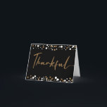 Modern Script Thankful 50th Birthday Gold Black Bedankkaart<br><div class="desc">Pas deze 50e verjaardag aan dank u gevouwen kaart met uw speciale groet en naam. Met gedrukte gouden witte confetti stippen met het woord "Thankful" in een modern script lettertype. Het bericht dat zich binnen bevindt, kan gemakkelijk worden aangepast met je eigen woorden. Ik dank uw gasten voor de viering...</div>