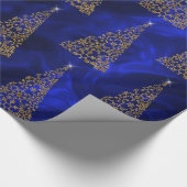 Moderne gouden kerstbomen op blauwe zijde cadeaupapier (Hoek)