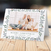 Moderne kerstavond en botanische bessen feestdagen kaart