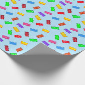 Moderne meerkleurige zoete beren op blauw cadeaupapier (Hoek)