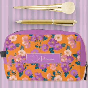 Moderne roze en paarse bloemen op oranje toilettasje