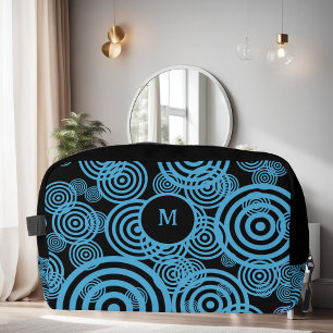 Moderne, trendy blauwe cirkels op zwart monogram toilettasje