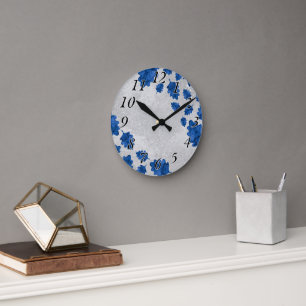 Moderne wandklok, blauwe bladeren op betonnen text ronde klok