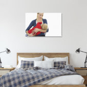 Moeder geeft haar baby. canvas afdruk (Insitu (Slaapkamer))