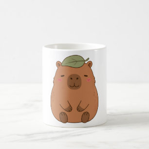 Mok met knappe capybara met groen blad op de kop