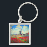Monet Tulips Windmill Sleutelhanger<br><div class="desc">Sleutelhanger met de bloem van Claude Monet en het schilderij van de windmolen. Mooie en kleurrijke velden van rode,  roze en gele tulpen naast een windmolen en huis in Nederland. Een geweldige cadeau van Monet voor supporters van indrukwekkende tonen en Franse kunst.</div>