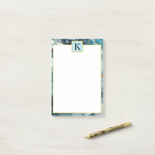 Monogram met blauwe en goudglittermarmer post-it® notes (Op bureau)