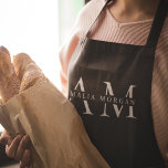 Monogram zwart gepersonaliseerd Schort<br><div class="desc">Kook in stijl met dit Monogram Zwart Gepersonaliseerd Schort. Dit schort heeft een strak zwart design en een aanpasbaar monogram en voegt een vleugje verfijning toe aan elke keuken. Gemaakt van duurzame en hoogwaardige materialen, biedt het zowel comfort als bescherming, waardoor het perfect is voor zowel amateur- als professionele chef-koks....</div>