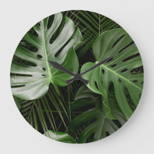 Monstera bladeren, luxe tropische lay-out. grote klok