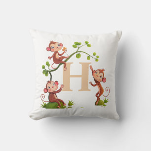 Mooie drie apen en gouden monogram op wit kussen
