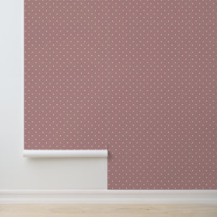 Mooie ivoorwitte stippen op terracotta roze behang