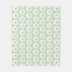 Mooie madeliefjesbloem op lichtgroen fleece deken