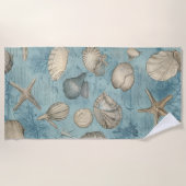 Mooie zeeschelpen in blauw strandlaken (Voorkant)