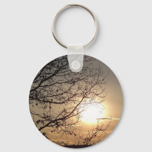 Mooie zonsondergang met takken sleutelhanger