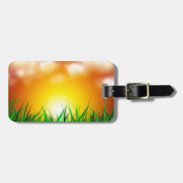 Mooie zonsopgang over een grasveld bagagelabel