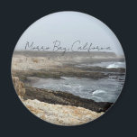 Morro Bay California Coastal Photography Magneet<br><div class="desc">A foggy overcast day in Morro Bay California with the ocean waves hitting the rocks on the shore in this beach photograph souvenir. This seaside travel photo keepsake magnet features black cursive script above the beach rocks and grey sky.</div>