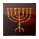 Moshe's Menorah Tegeltje<br><div class="desc">Een zeer zeven-vertakte menorah bovenop een donkere bergachtige achtergrond. In de Torah Moshe Rabbenu wordt gezegd: "Je zult een Menorah van zuiver goud maken, geslagen, de Menorah wordt gemaakt, zijn basis, zijn tak, zijn goblets, zijn knoppen, en zijn bloemen zullen er vanaf worden gehammerd, " [Shmot 25:31] en later, "Zie,...</div>