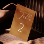 Mosterdbruin minimalistisch script herfstbruiloft kaart<br><div class="desc">Deze elegante trouwtafel nummerkaart heeft een rijke mosterdbruine achtergrond in combinatie met een delicaat wit script en gedurfde nummering voor een schone, moderne look. De warme gekruide okertint geeft het een uitnodigend, aards gevoel - perfect voor herfstbruiloften, rustieke recepties of gezellige buitenvieringen. Minimalistisch maar toch opvallend, dit ontwerp voegt warmte...</div>