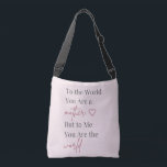 Mother Quote Pink Crossbody Tas<br><div class="desc">Celebrate Mom with this elegant tote bag featuring the heartfelt quote “To the World You Are a Mother, But to Me You Are the World.” Designed with soft blush pink tones and modern typography, this stylish bag blends sentiment with everyday practicality. Perfect for shopping, daily errands, or thoughtful Mother’s Day...</div>