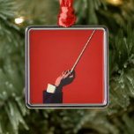 muziek, hand van de geleider die een batterij vas metalen ornament<br><div class="desc">Een  ontwerp voor illustratiemuziek met de arm en de hand van een dirigent die een baton vasthouden die klaar is om een klassieke muziekuitvoering te leiden. Op een rode achtergrond.</div>