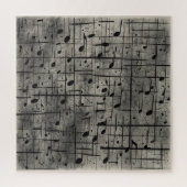 Muzikale noten op donkere houtskooltextuur legpuzzel (Verticaal)