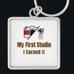 My First Studio Keychain – I Earned It – Proud Fir<br><div class="desc">Celebrate the pride of owning your very first studio! This keychain features the bold phrase "My First Studio – I Earned It", perfect for anyone who worked hard to achieve this milestone. Whether it’s an art studio, photography space, music room, or creative workshop, this keychain is a fun and meaningful...</div>
