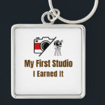My First Studio Keychain – I Earned It – Proud Fir<br><div class="desc">Celebrate the pride of owning your very first studio! This keychain features the bold phrase "My First Studio – I Earned It", perfect for anyone who worked hard to achieve this milestone. Whether it’s an art studio, photography space, music room, or creative workshop, this keychain is a fun and meaningful...</div>