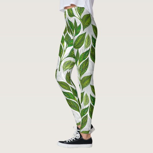 Naadloos patroon met groene theelbladeren leggings (Links)