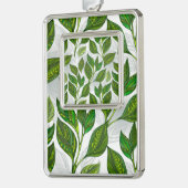 Naadloos patroon met groene theelbladeren verzilverd omlijst ornament (Links)