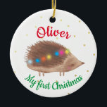 Naam Cute Hedgel Baby Eerste Kerstmis Keramisch Ornament<br><div class="desc">Een gepersonaliseerde eerste kerstversiering van baby,  met een schattige versierde egelafbeelding op een witte achtergrond,  met kleine gouden gestippelde sneeuwvlokken. De naam van een baby of een baby meisje is het eerste kerstontwerp.</div>