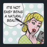 Natuurlijke Beauty Comic Book Wall klok<br><div class="desc">Deze witte muurklok brengt zeker een glimlach naar je lippen. De Natural Beauty Comic Book Wall Clock kenmerkt een mooie jonge vrouw die rode lippenstift aanbrengt en een spraakballetje dat zegt: "Het is niet makkelijk om een natuurlijke schoonheid te zijn." Het meisje en de spraakbel zitten op een roodblauwe, polka...</div>